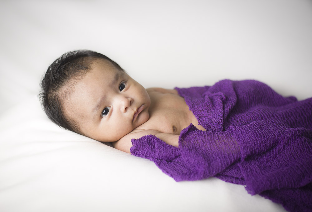 Baby wraped in a purple blanket